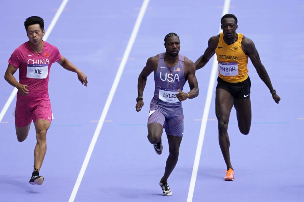 Noah Lyles, of the United States, runs in a men’s 100 meters round 1 heat at the 2024 Summer Olympics, Saturday, Aug. 3, 2024, in Saint-Denis, France. (AP Photo/Martin Meissner)