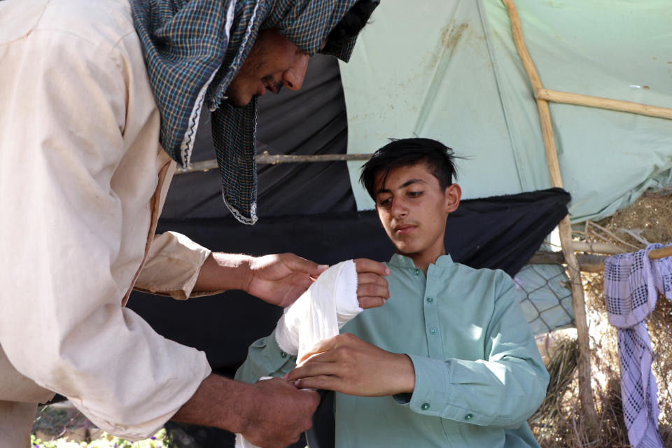 An Afghan youth receives medical care after being injured in fighting between the Taliban and Afghan security forces, in Mazar-e-Sharif, Afghanistan, Tuesday, Aug. 10, 2021. (AP Photo/Mirwais Bezhan)