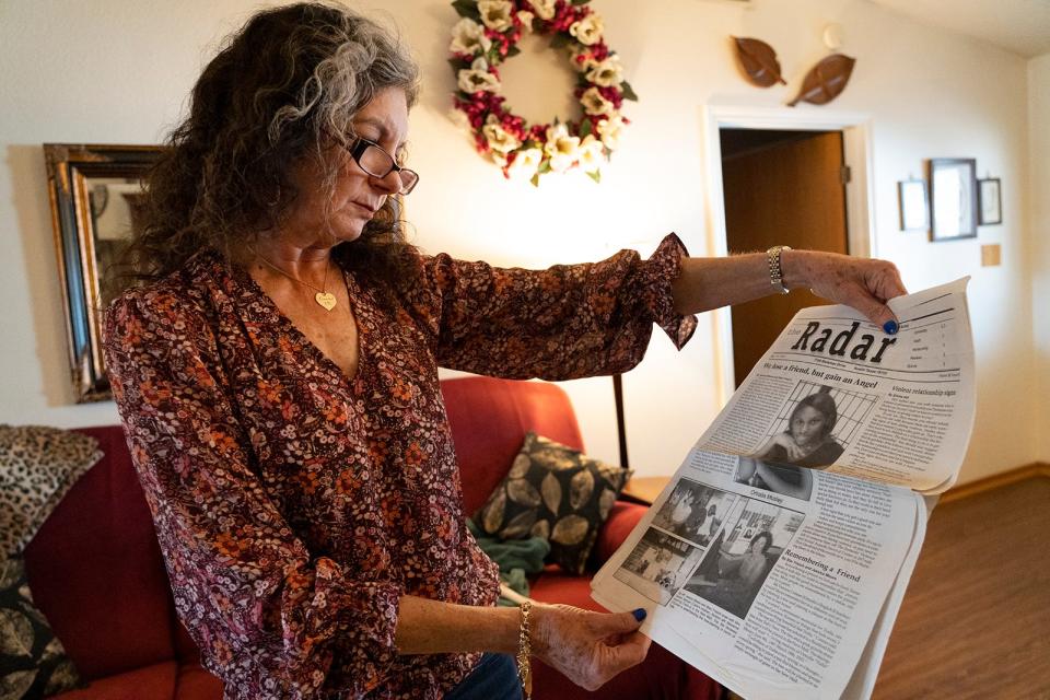 Vanessa Conner holds the school newspaper that honored Ortralla Mosley following her death as she recalls memories of Mosley while in her home in Liberty Hill Wednesday, Feb. 8, 2023. 