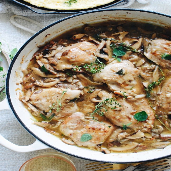 Chicken with leeks and mushrooms in a Dutch oven.