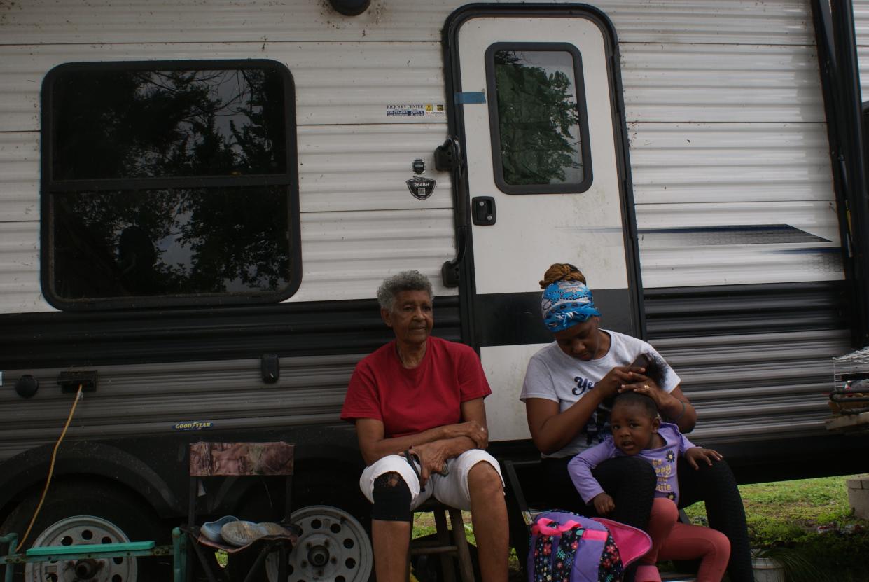 Mabel Johnson, her granddaughter Tiara Johnson and child sit outside her state-provided Ida Shelter camper. The campers were provided to Hurricane Ida survivors in 2021. The program ends April 30, 2024, and the family has nowhere to go.
