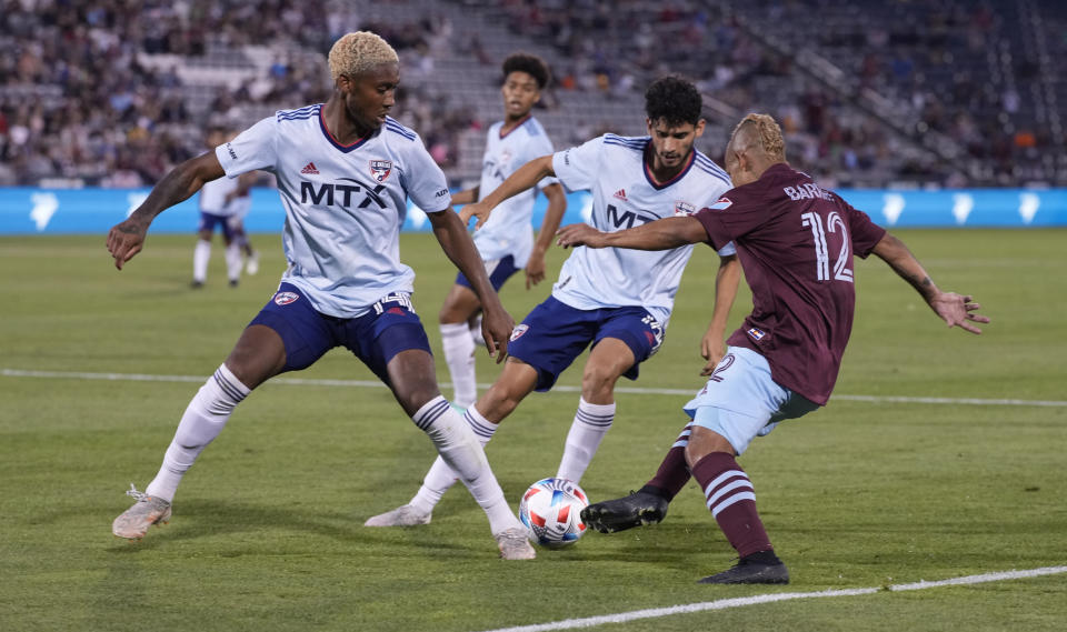 Colorado Rapids forward Michael Barrios, right, loses control of the ball as FC Dallas defender Nkosi Burgess, left, and forward Ricardo Pepi defend during the second half of an MLS soccer match Wednesday, July 21, 2021, in Commerce City, Colo. The Rapids won 2-0. (AP Photo/David Zalubowski)