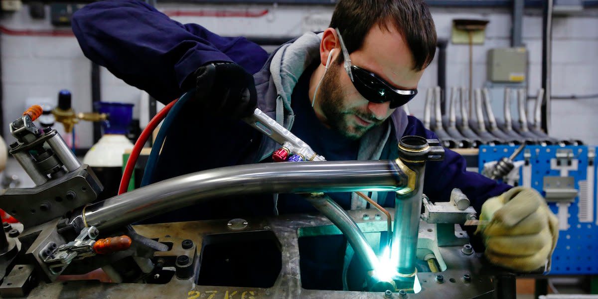 Musa Aumeed brazes a bike frame at the Brompton Bicycle factory in west London January 10, 2014. Loan refusal letters and retailers' rejections frame the walls of the Brompton Bicycle factory, a reminder of the obstacles the firm has overcome to establish itself as the UK's top bike-maker, selling 45,000 a year around the world.