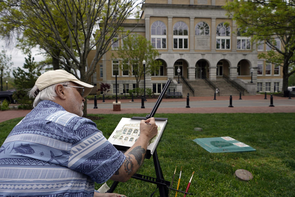 Gerald Hatley, of Bella Vista, Ark., sketches the Bentonville Courthouse on the town square Wednesday, April 19, 2023, in Bentonville, Ark. (AP Photo/Sue Ogrocki)