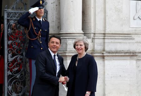 British Prime Minister Theresa May (R) shakes hand with her Italian counterpart Matteo Renzi (L) during a meeting in Rome July 27, 2016. REUTERS/Remo Casilli