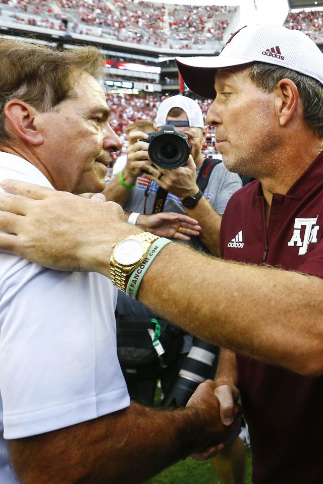 FILE - Alabama head coach Nick Saban shakes hands with Texas A&M head coach Jimbo Fisher after the end of an NCAA college football game, Saturday, Sept. 22, 2018, in Tuscaloosa, Ala. Texas A&M coach Jimbo Fisher called Nick Saban a “narcissist” Thursday, May 19, 2022, after the Alabama coach made “despicable” comments about the Aggies using name, image and likeness deals to land their top-ranked recruiting classes. Saban called out Texas A&M on Wednesday night for “buying” players. (AP Photo/Butch Dill, File)