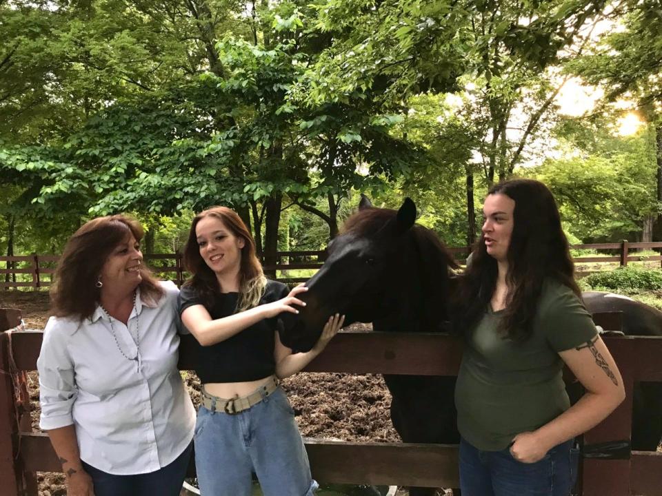 The McKenna family with "Whiskey," one of their horses.