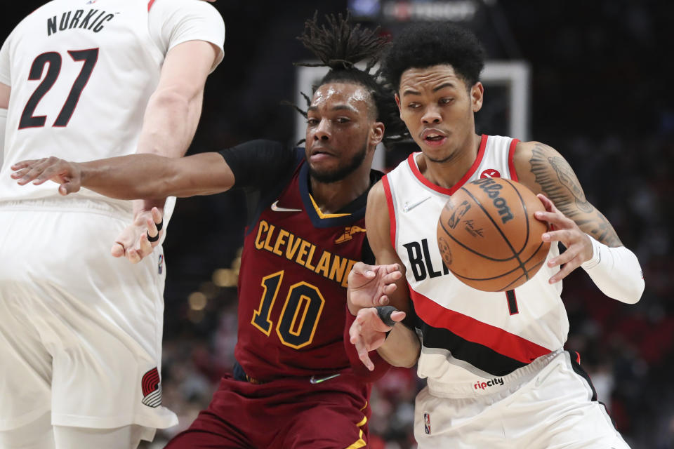 Cleveland Cavaliers guard Darius Garland defends against Portland Trail Blazers guard Anfernee Simons, right, during the first half of an NBA basketball game in Portland, Ore., Friday, Jan. 7, 2022. (AP Photo/Amanda Loman)