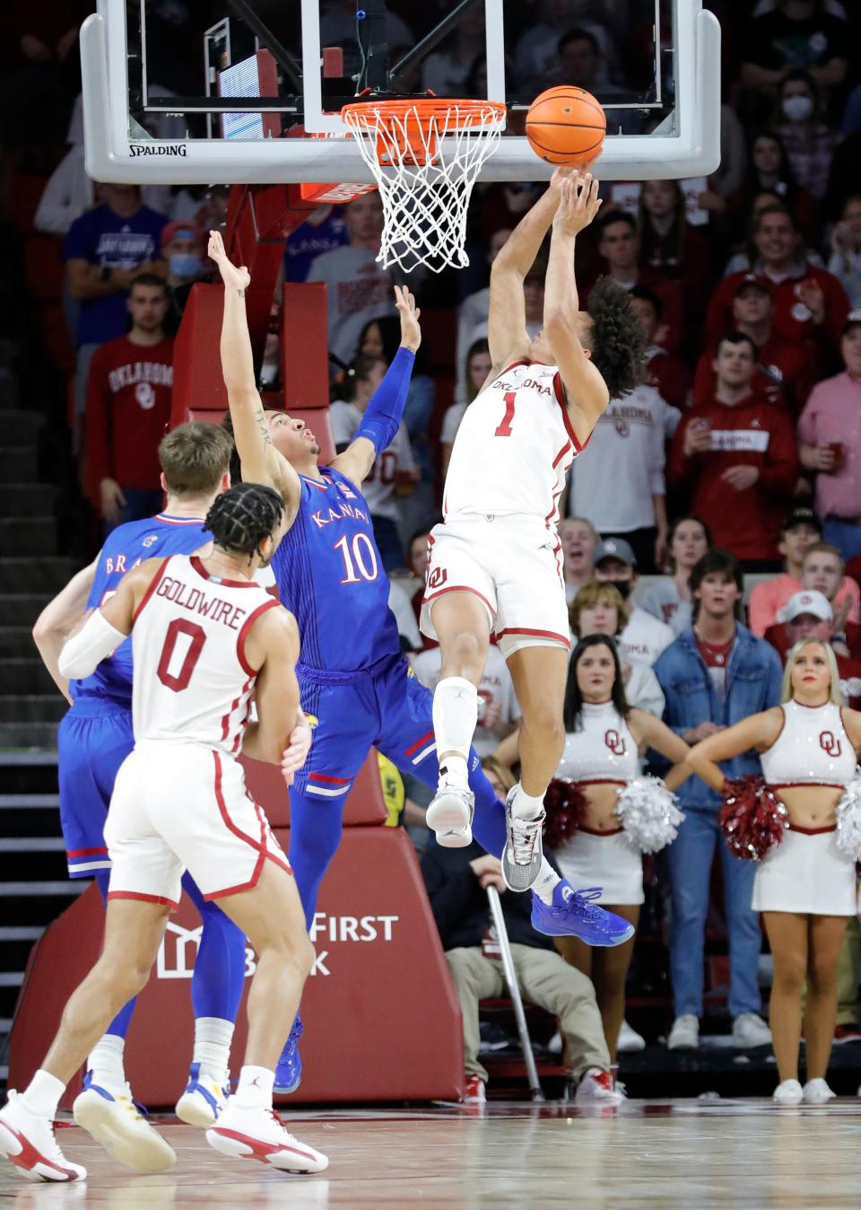 Kansas' Christian Braun and Jalen Wilson defend as Oklahoma tries for a bucket during the men's basketball game Tuesday in Norman, Oklahoma between the Jayhawks and Sooners.