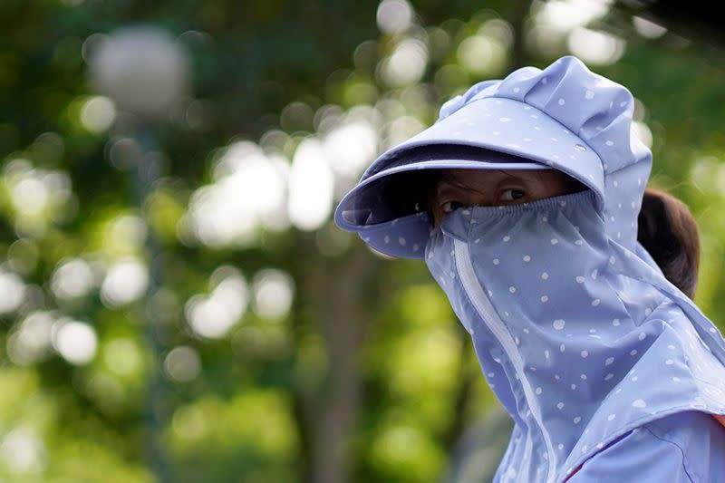 A woman wearing a face mask is seen on a street following an outbreak of the novel coronavirus disease (COVID-19), in Shanghai