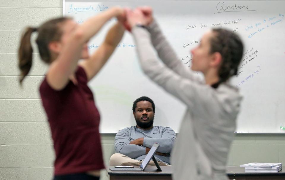 Local dancer and choreographer Dominic Moore-Dunson, center, observes as Anna Baugham and Stephanie Roston work through the idea of memory loss during the first rehearsal for his project "The Remember Balloons" at Guzzetta Hall Dec. 7 in Akron.