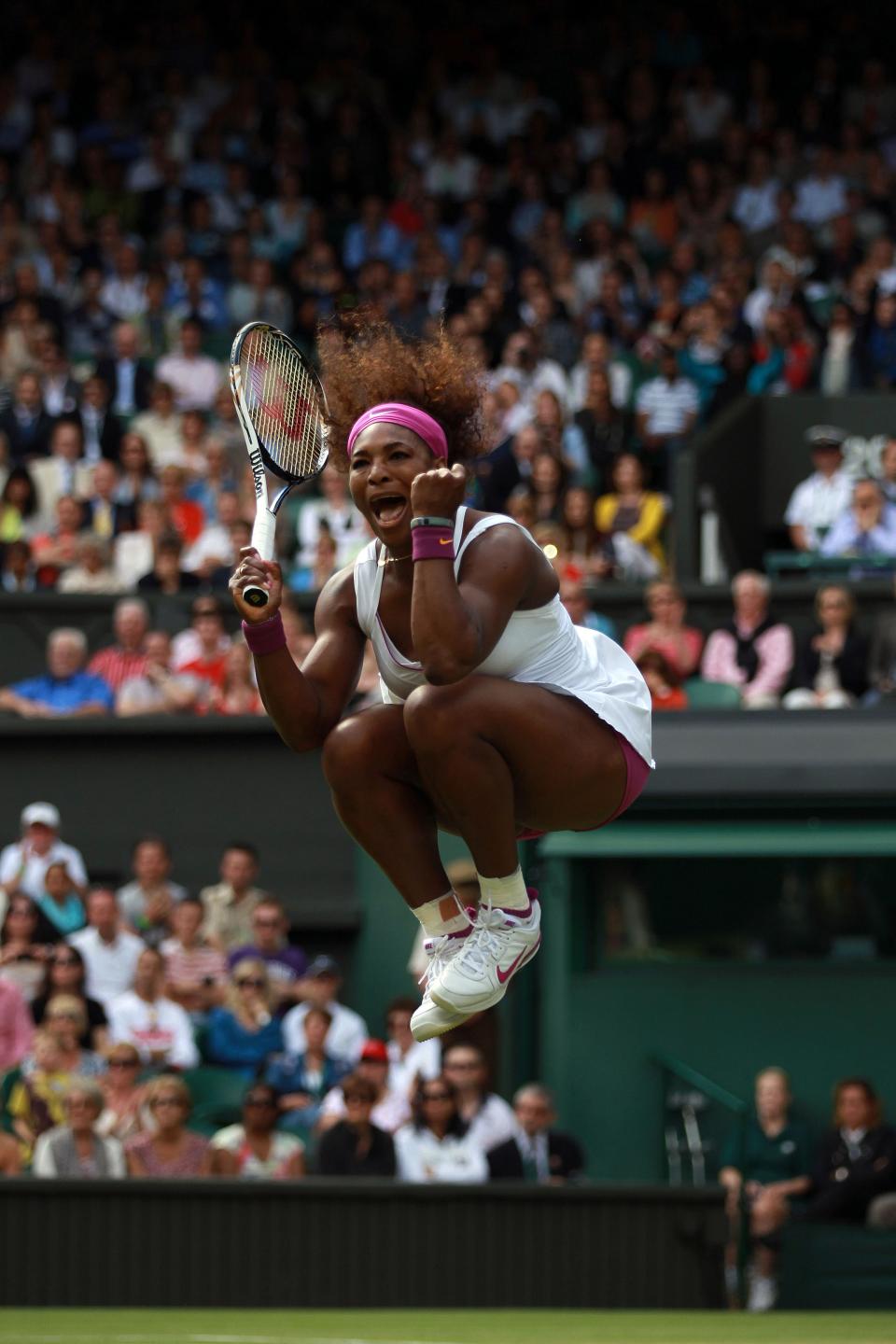 Serena Williams jumps for joy after winning her third-round match at Wimbledon in 2012.