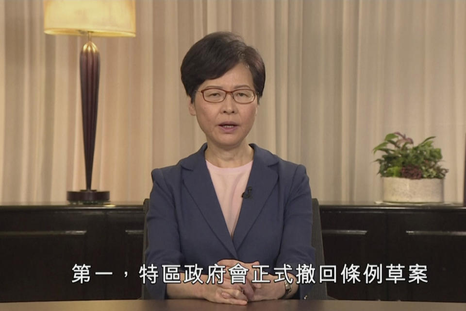 In this image made from video provided Wednesday, Sept. 4, 2019 by Hong Kong Government Information Services, Hong Kong Chief Executive Carrie Lam speaks in the television message, in Hong Kong. Chief Executive Lam announced Wednesday the government will formally withdraw an extradition bill that sparked months of demonstrations, bowing to one of the protesters' demands in the hope of ending the increasingly violent unrest. The words, bottom, read "First, the government will officially withdraw the bill." (Hong Kong Government Information Services via AP)