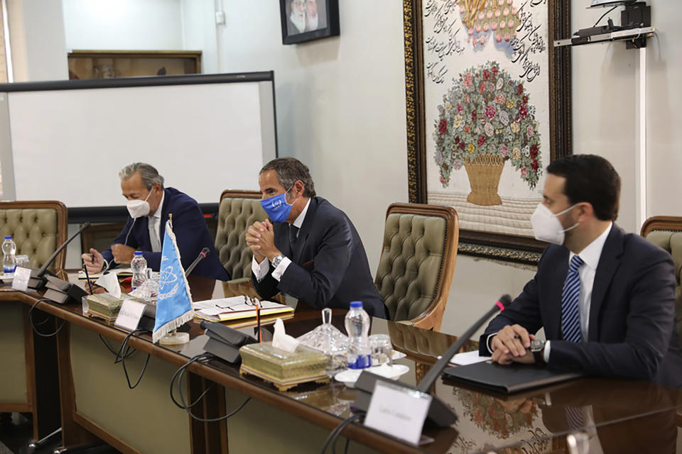 Rafael Mariano Grossi, Director General of International Atomic Energy Agency, IAEA, center, attends a meeting with the Head of Atomic Energy Organization of Iran, Mohammad Eslami, in Tehran, Iran, Sunday, Sept. 12, 2021. Iran agreed Sunday to allow international inspectors to install new memory cards into surveillance cameras at its sensitive nuclear sites and to continue filming there, averting a diplomatic showdown this week. (Atomic Energy Organization of Iran via AP)