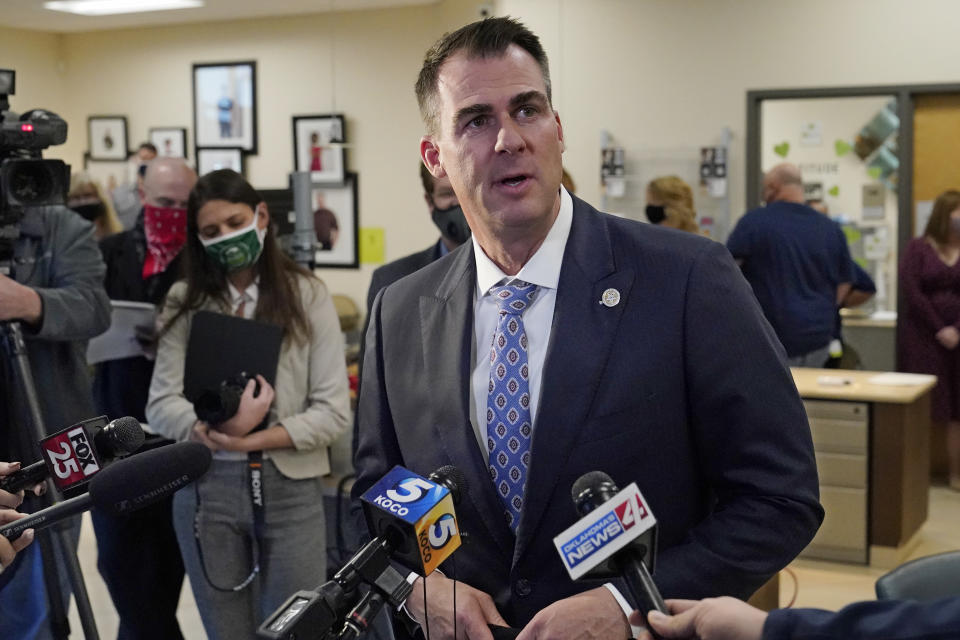 Oklahoma Gov. Kevin Stitt talks with the media before donating convalescent plasma at the Oklahoma Blood Institute in Oklahoma City, Tuesday, Dec. 1, 2020. This is Gov. Stitt's second time donating plasma since he tested positive for the coronavirus in July. (AP Photo/Sue Ogrocki)