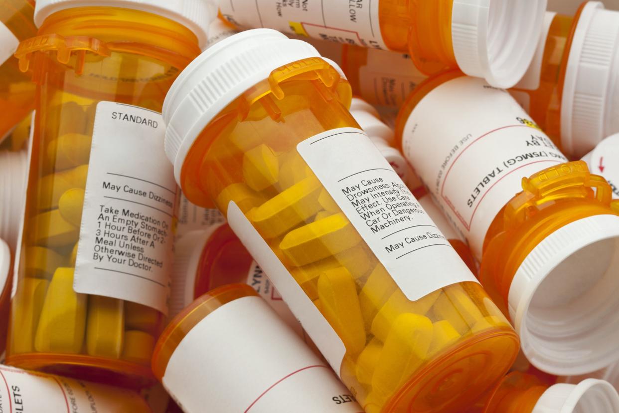 several prescription pill bottles in a pile