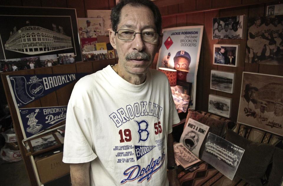 Ron Schweiger, Brooklyn's official borough historian, at his home where he has an extensive Brooklyn Dodgers memorabilia collection on Thursday, Sept. 20, 2012. After decades without a professional sports team following the Dodgers move west, Brooklyn is hitting the major leagues again with a new arena and the Brooklyn Nets' NBA franchise. Schweiger says the new stadium will help replace the sense of loss felt longtime residents for many years after the Dodgers left. (AP Photo/Bebeto Matthews)