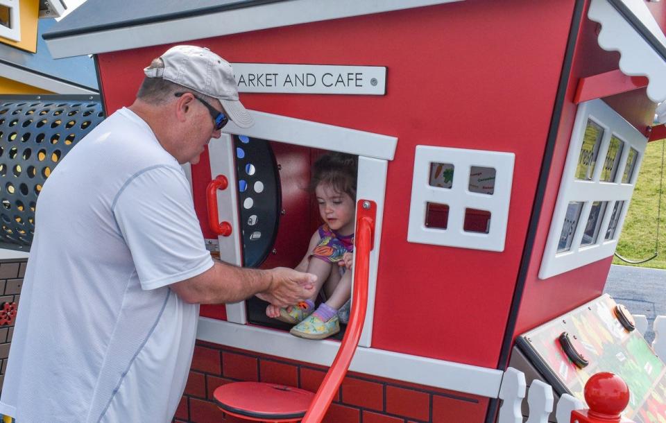 Jeff Osborne plays store with his 3-year-old granddaughter, Ada Osborne, at Kiwanis Play Park on May 23.