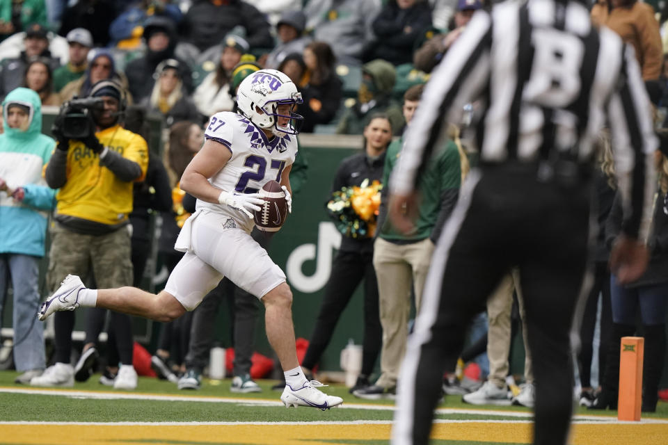 TCU wide receiver Gunnar Henderson (27) runs for a touchdown during the second half of an NCAA college football game against Baylor in Waco, Texas, Saturday, Nov. 19, 2022. TCU won 29-28. (AP Photo/LM Otero)