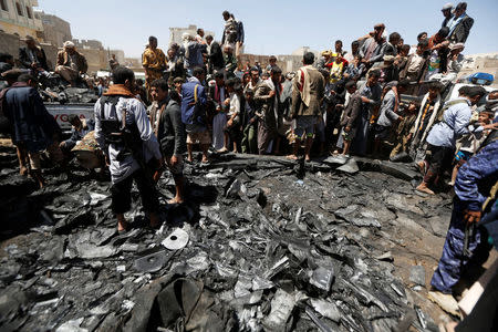 People gather at the site of the wreckage of a drone aircraft which the Houthi rebels said they have downed in Sanaa, Yemen October 1, 2017. REUTERS/Khaled Abdullah