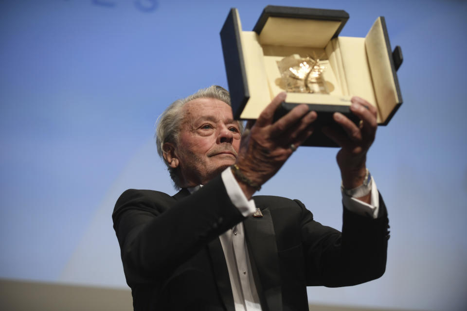 <p>FILE - Actor Alain Delon holds aloft his honorary Palme D'Or award at the 72nd international film festival, Cannes, southern France, Sunday, May 19, 2019. Alain Delon, the internationally acclaimed French actor who embodied both the bad guy and the policeman and made hearts throb around the world, has died at age 88, French media reported. (Photo by Arthur Mola/Invision/AP)</p>
