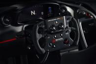 <p>The D-shaped steering wheel is now trimmed with microsuede and the Senna family's logo.</p>