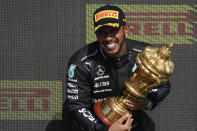 Mercedes driver Lewis Hamilton of Britain celebrates on the podium after winning the British Formula One Grand Prix, at the Silverstone circuit, in Silverstone, England, Sunday, July 18, 2021. (AP Photo/Jon Super)