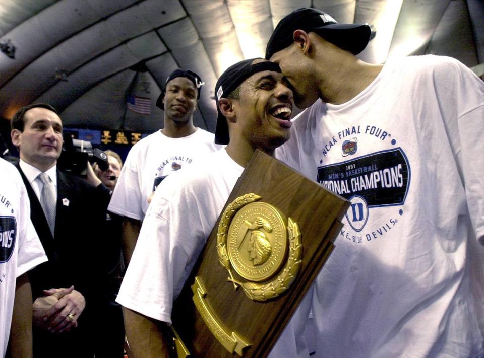 Duke’s Shane Battier, right, shares a moment with Jason Williams as coach Mike Krzyzewski looks on after the Blue Devils win over Arizona in the national title game in 2001 in Minneapolis, MN.