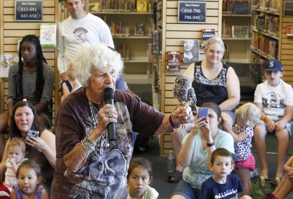 Doris Mager, 90, shows a screech owl named Impy to the crowd of about 65 people recently attending her presentation at the West Richland branch of Mid-Columbia Libraries.