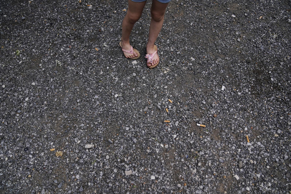 Avery Moore, 4, of Athens, Ala., waits for her grandfather to come outside on Thursday, June 23, 2022, in Athens, Ala. "Where is Uncle David again, is he coming home soon," says Avery. Her mother says she is still confused about where her uncle is and why he hasn't come back home. David Guess' killing drew little attention outside the rural stretch of northern Alabama where Guess grew up, though his death shattered many lives. (AP Photo/Brynn Anderson)