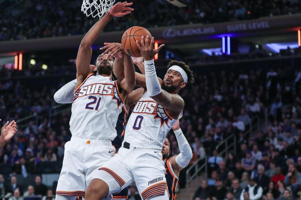 Phoenix Suns forward Keita Bates-Diop (21) and guard Jordan Goodwin (0) go after a rebound in the first quarter against the New York Knicks at Madison Square Garden on Nov. 26, 2023.