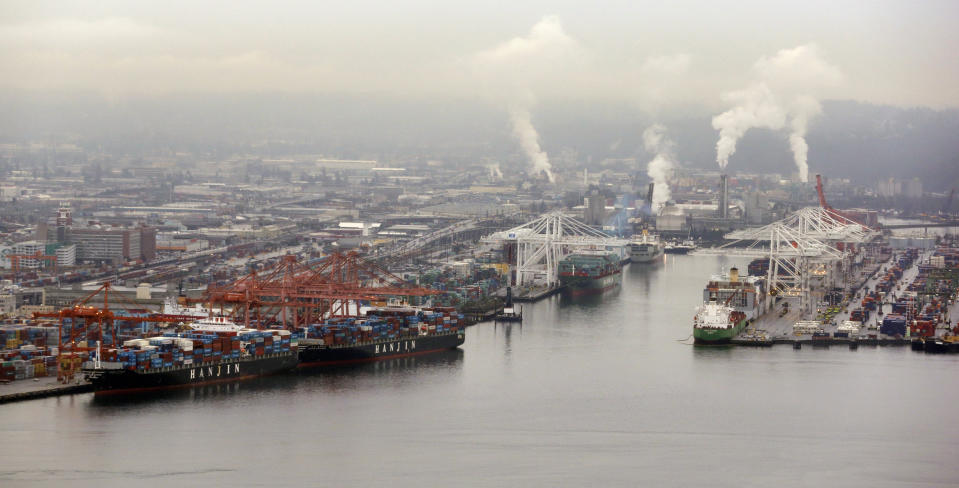 FILE - Container ships are docked at the Port of Seattle along the Duwamish River, Feb. 4, 2015, in Seattle. Ending an eight-year legal battle, chemical giant Monsanto has agreed to a $160-million settlement with Seattle for its part in polluting the Lower Duwamish River with toxins that posed a threat to humans and wildlife, the city attorney's office said in a press release Thursday, July 25, 2024. (AP Photo/Elaine Thompson, File)