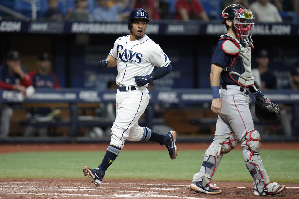 Tampa Bay Rays' Francisco Mejia, right, scores past Boston Red Sox catcher Connor Wong on an RBI single by Taylor Walls during the fifth inning of a baseball game Wednesday, Sept. 7, 2022, in St. Petersburg, Fla. (AP Photo/Chris O'Meara)