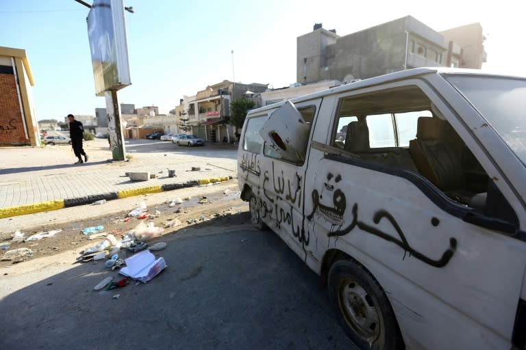 A damaged van lies on a road in the Hay al-Andalus neighbourhood of the Libyan capital Tripoli on March 14, 2017, following clashes between rival armed groups