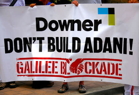 FILE PHOTO: Protesters against the Indian conglomerate Adani Enterprises hold a banner outside the venue for the Australian diversified mining contractor Downer EDI Limited's annual general meeting (AGM) in Sydney, Australia, November 2, 2017. REUTERS/David Gray/File Photo