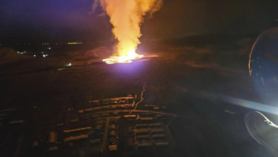 In this photo provided by Civil Protection taken from the Coast Guard's helicopter, a view of lava as the volcano erupts near Grindavík, Iceland, Sunday, Jan. 14. 2024. A volcano has erupted in southwestern Iceland, sending semi-molten rock spewing toward a nearby settlement for the second time in less than a month. Iceland's Icelandic Meteorological Office says the eruption Sunday came after a swarm of earthquakes near the town of Grindavik. (Icelandic Civil Protection via AP)