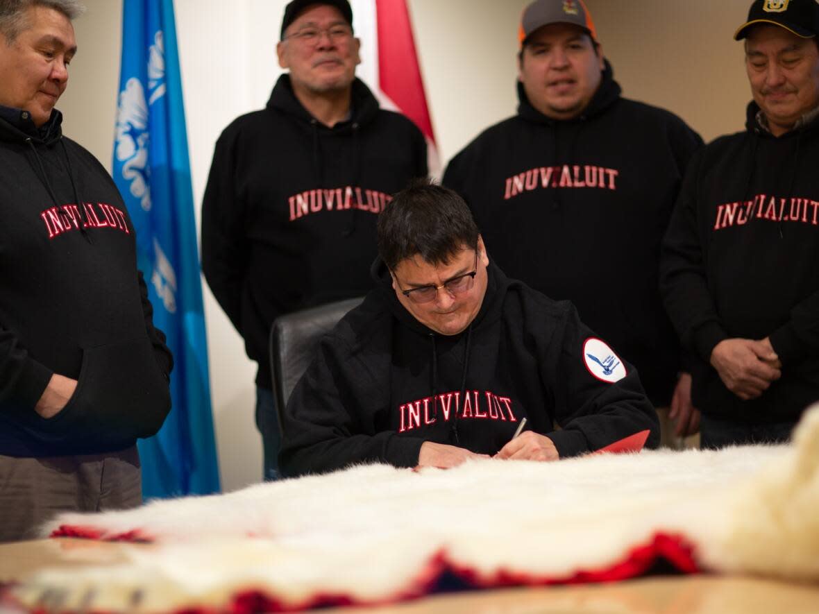 The signing the Inuvialuit Qitunrariit Inuuniarnikkun Maligaksat (Inuvialuit Family Way of Living Law) on Nov. 24, 2021. From left to right: Lawrence Ruben, Gerald Inglangasuk, Duane Ningaqsiq Smith, Jordan McLeod, John Lucas Jr.   (Submitted by Inuvialuit Regional Corporation. - image credit)