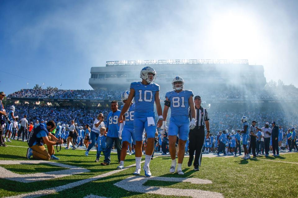 North Carolina Tar Heels quarterback Drake Maye walk out before the game against the Syracuse Orange at Kenan Memorial Stadium.