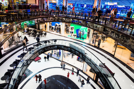 People walk through the Mall of Berlin shopping centre during its opening night in Berlin, September 24, 2014. REUTERS/Thomas Peter/File Photo GLOBAL BUSINESS WEEK AHEAD PACKAGE - SEARCH "BUSINESS WEEK AHEAD JULY 18" FOR ALL IMAGES