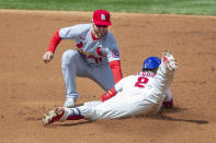 Philadelphia Phillies' Jean Segura, right, is safe at second on a double before St. Louis Cardinals shortstop Paul DeJong, left, can make the tag during the second inning of a baseball game, Sunday, April 18, 2021, in Philadelphia. (AP Photo/Laurence Kesterson)