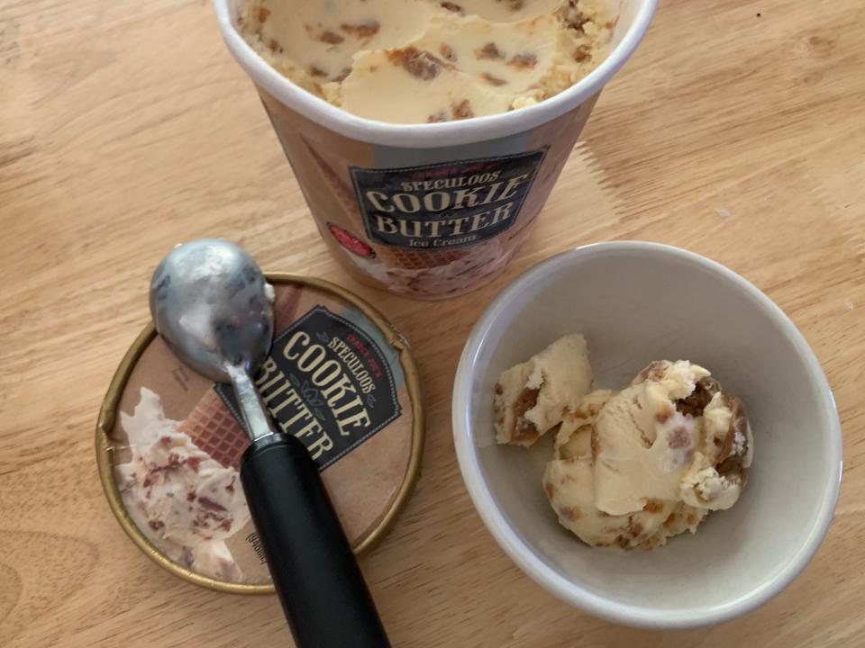 open carton of Trader Joe's cookie butter ice cream beside white bowl of it
