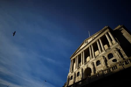 FILE PHOTO - A bird flies past The Bank of England in the City of London, Britain, December 12, 2017. REUTERS/Clodagh Kilcoyne