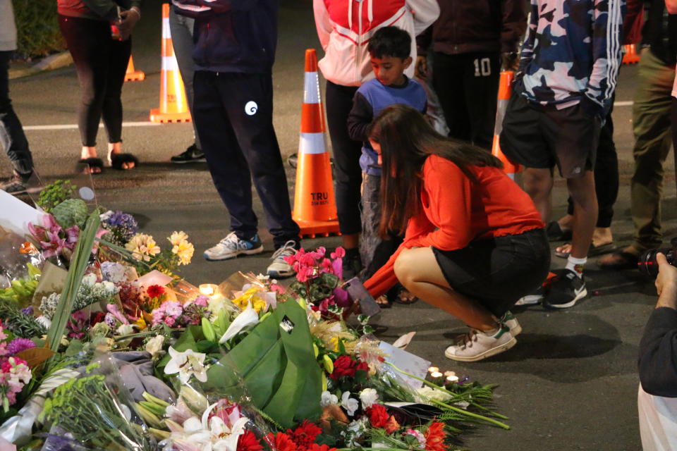 A young girl seen laying down flowers to pay respect to the victims of the Christchurch mosques shooting. Source: AAP