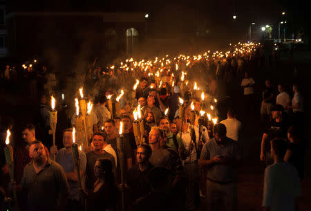 White nationalists carry torches on the grounds of the University of Virginia, on the eve of a planned Unite The Right rally in Charlottesville, Virginia (Reuters)