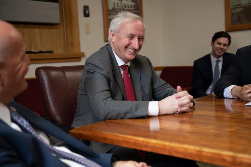 Deputy Attorney General Jeffrey Rosen smiles while meeting with other officials after the completion of a tour of the Englewood Federal Correctional Institution in Colorado