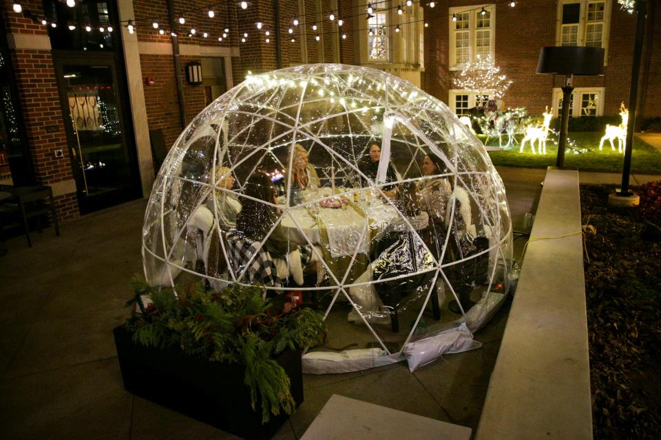 Customers enjoy drinks inside an igloo at the Purdue Union Club Hotel, Tuesday, Dec. 14, 2021 in Lafayette.
