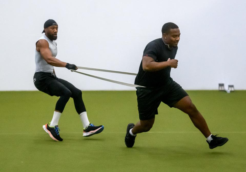 Ish Hicks, left, Geno Hess, a Peoria High grad, improve his speed and agility during a workout.