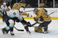 Vegas Golden Knights goaltender Adin Hill (33) stops a shot attempt by Seattle Kraken center Matty Beniers (10) during the first period of an NHL hockey game Friday, Nov. 25, 2022, in Las Vegas. (AP Photo/John Locher)