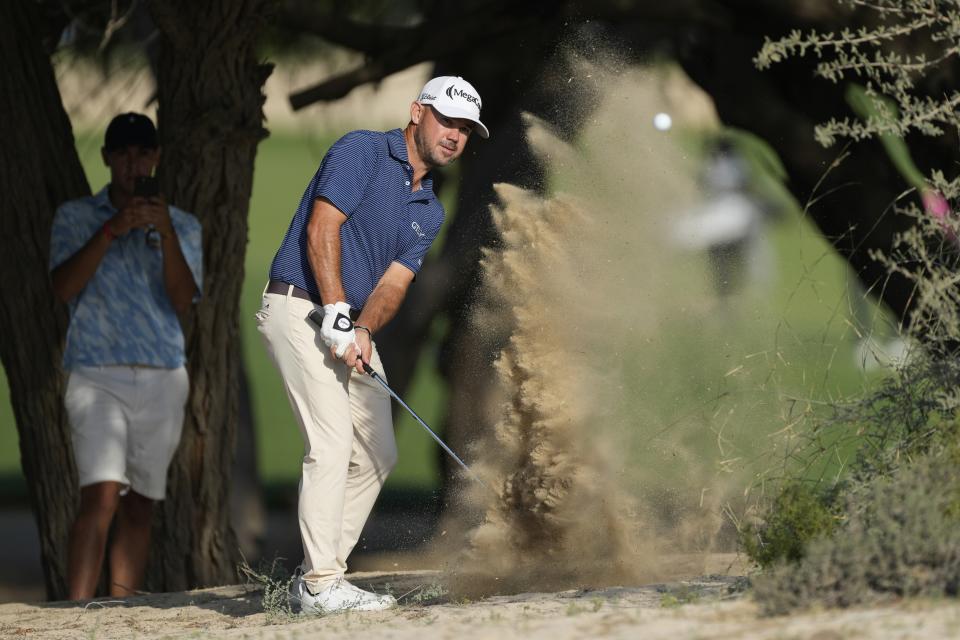 Brian Harman of the U.S. plays his second shot on 14th dirt during the second round of the Hero Dubai Desert Classic golf tournament, in Dubai, United Arab Emirates, Friday, Jan. 19, 2024. (AP Photo/Kamran Jebreili)