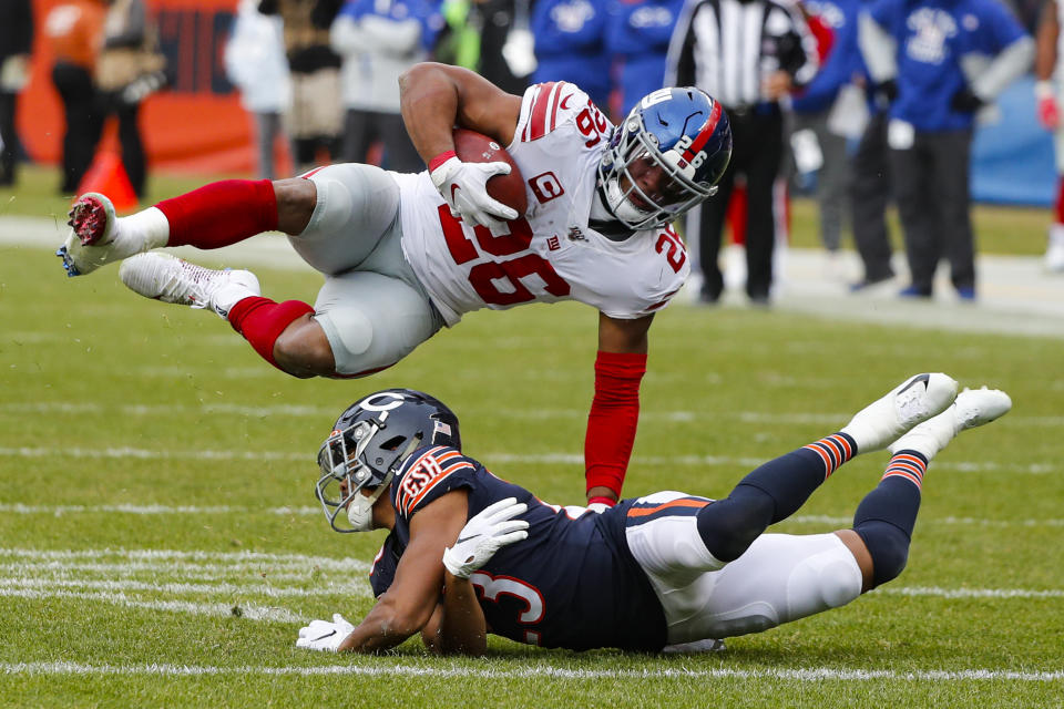 New York Giants running back Saquon Barkley (26) flips over Chicago Bears cornerback Kyle Fuller (23). (AP Photo/Charles Rex Arbogast)